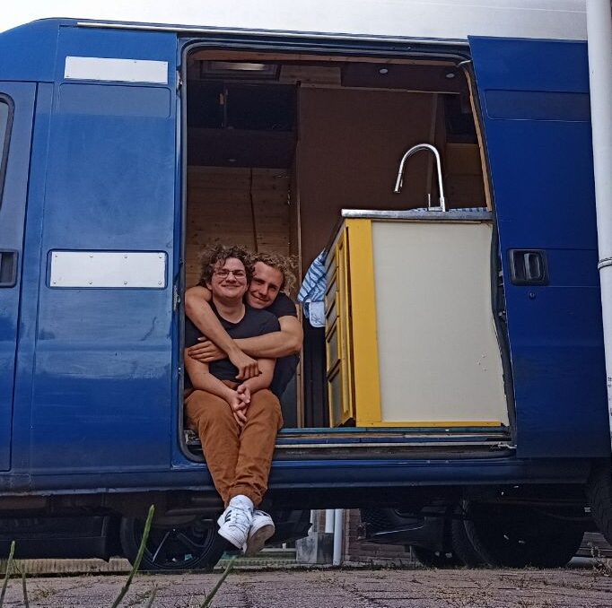 Noah and Julian in front of their campervan Limão